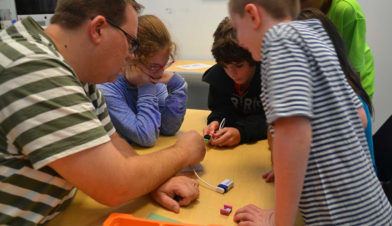 Man helping students with science experiment