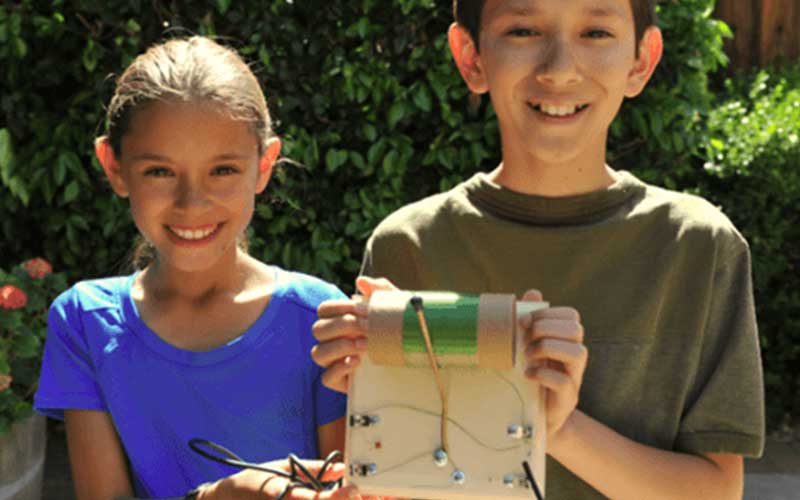 Children posing with their science project